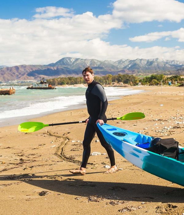 man-walking-on-the-beach-with-kayak-traveling-by-s-small.jpg